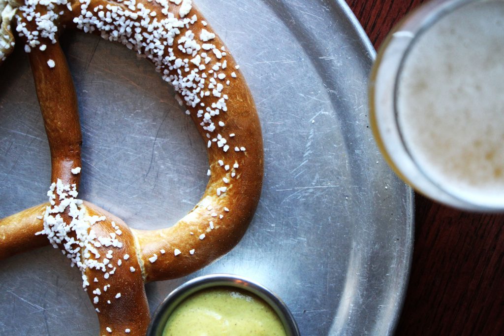 A salted soft pretzel with mustard